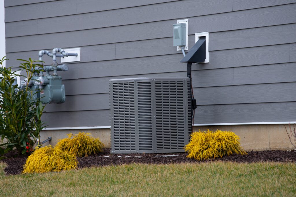 New outdoor air conditioning system installed beside a home by Dowd Heating & Air Conditioning for efficient residential cooling.