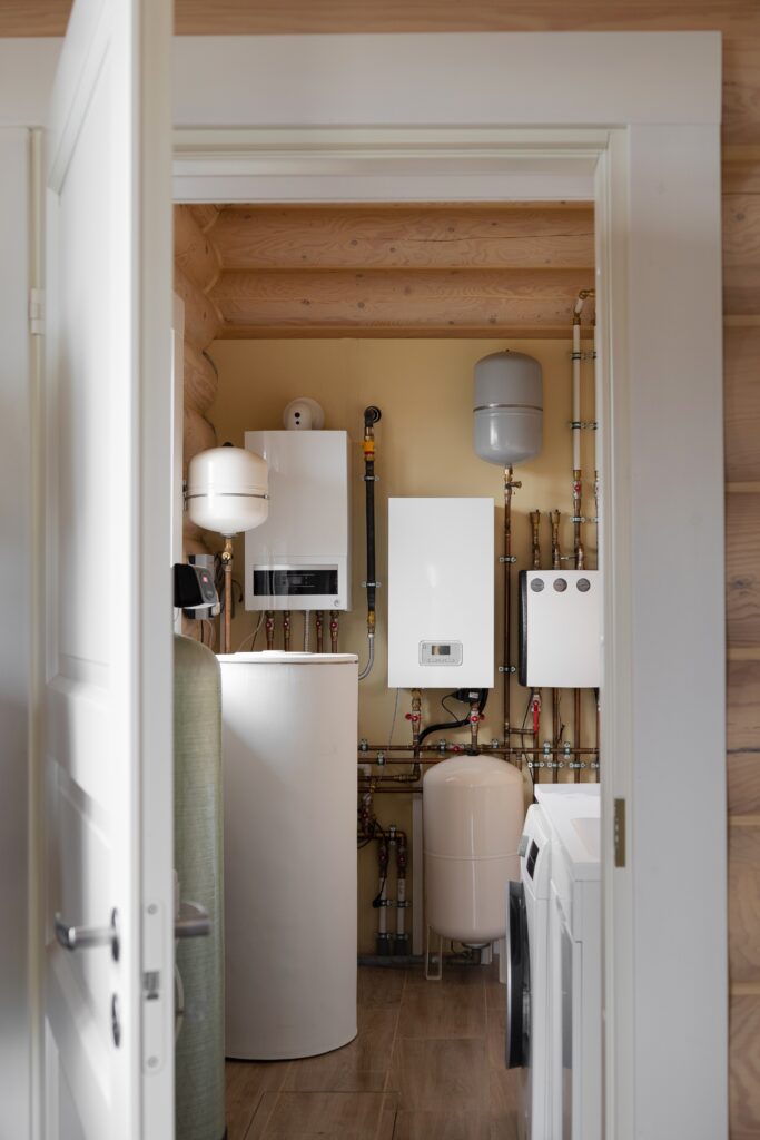 New residential boiler installation with integrated hydronic heating components and copper piping in a utility room