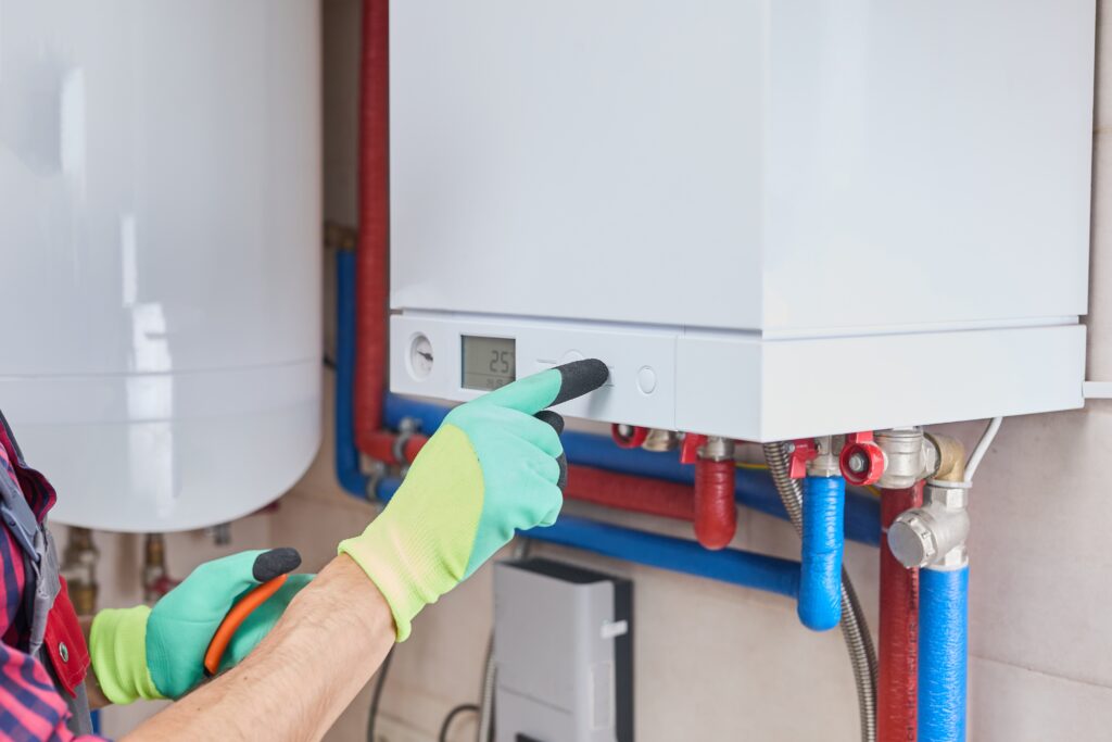 HVAC technician adjusting settings on a residential boiler system during professional boiler repair service