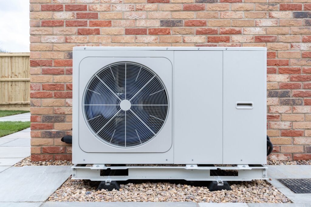 Outdoor heat pump unit installed beside a home to provide efficient heating and cooling year-round