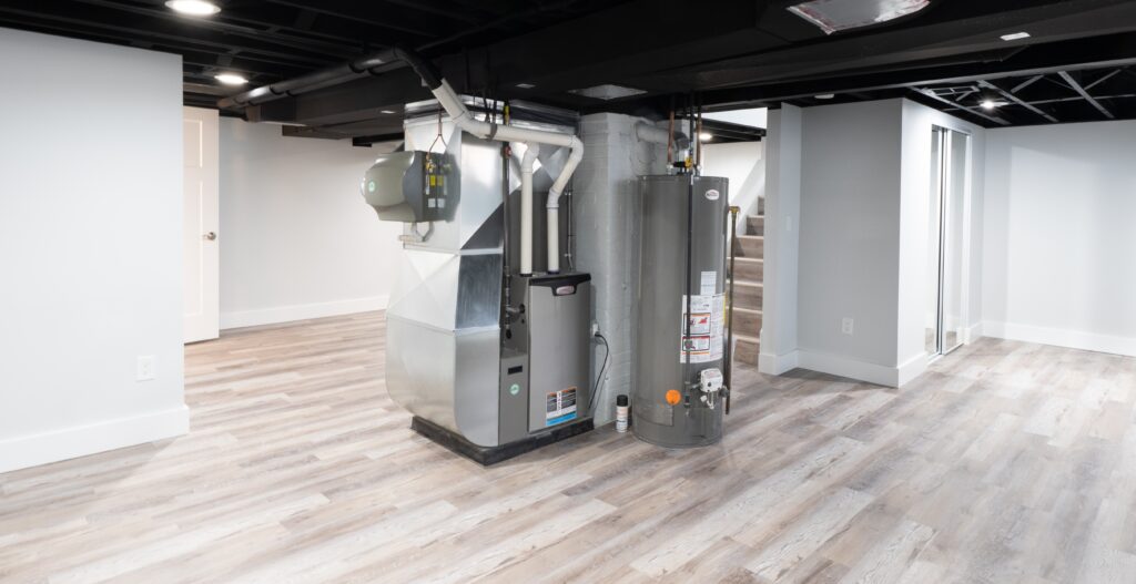Modern residential heating system with high-efficiency furnace and water heater installed in a finished basement