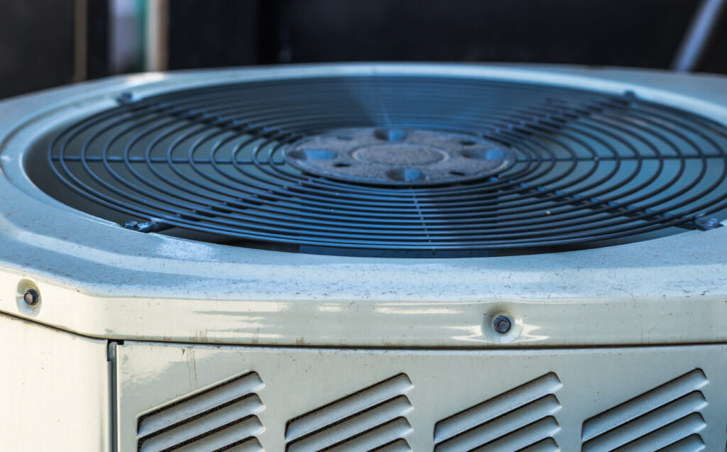 Close-up of an outdoor central air conditioning condenser unit used for residential HVAC cooling and air conditioning services by Dowd HVAC.