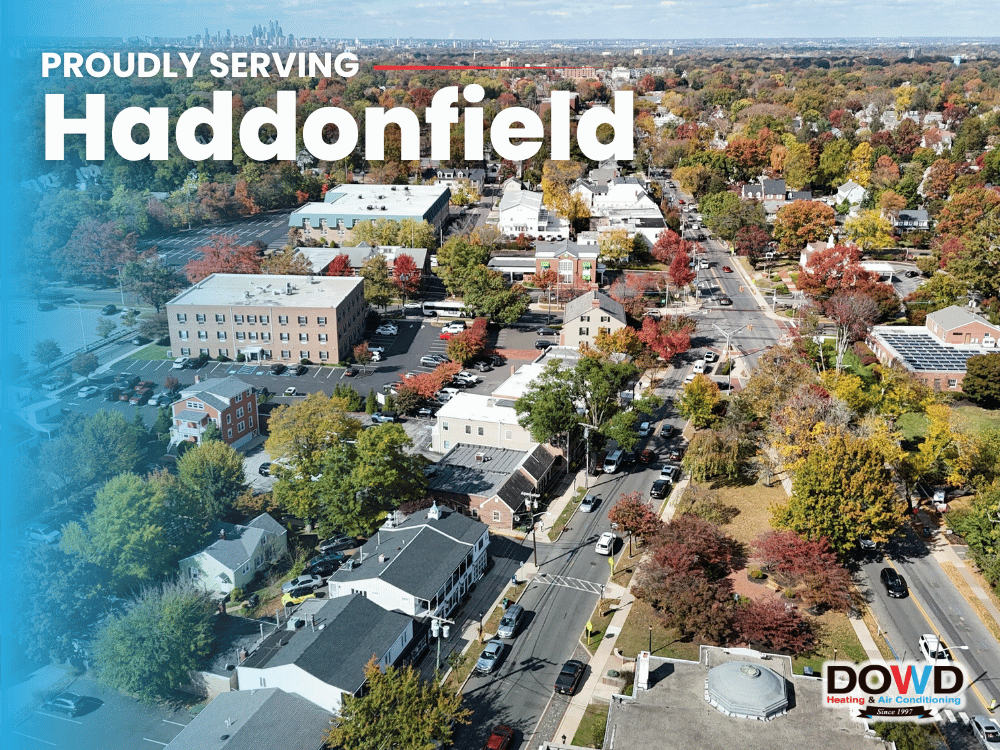 Aerial view of Haddonfield, NJ, featuring residential homes, local streets, businesses, and colorful fall trees with the Philadelphia skyline in the distance, serving Dowd Heating & Air Conditioning’s South Jersey service area.